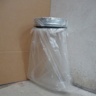 Round wall-mounted galvanised steel bin bag holder.