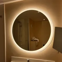 Illuminated round mirror for hotel rooms