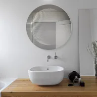 Round LED mirror with 3D effect for a modern touch.