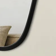 Distorted mirror with black wooden frame